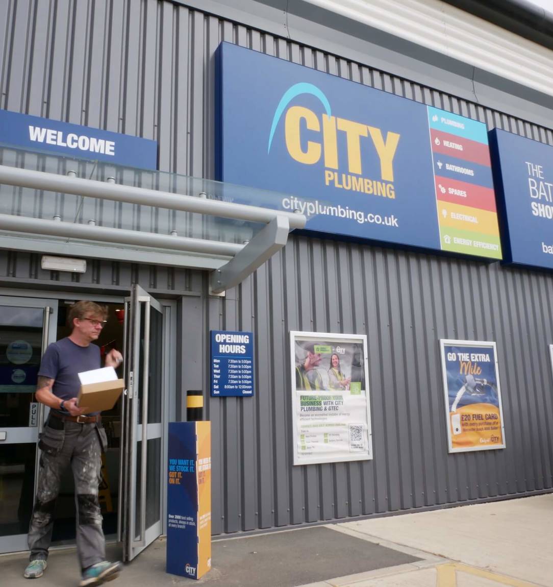 A customer leaving a City Plumbing and Bathroom Showroom store