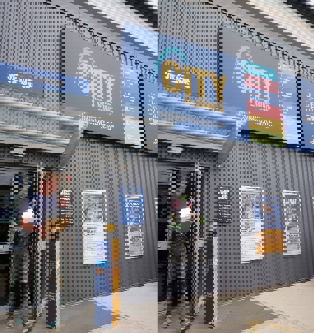 A customer leaving a City Plumbing and Bathroom Showroom store
